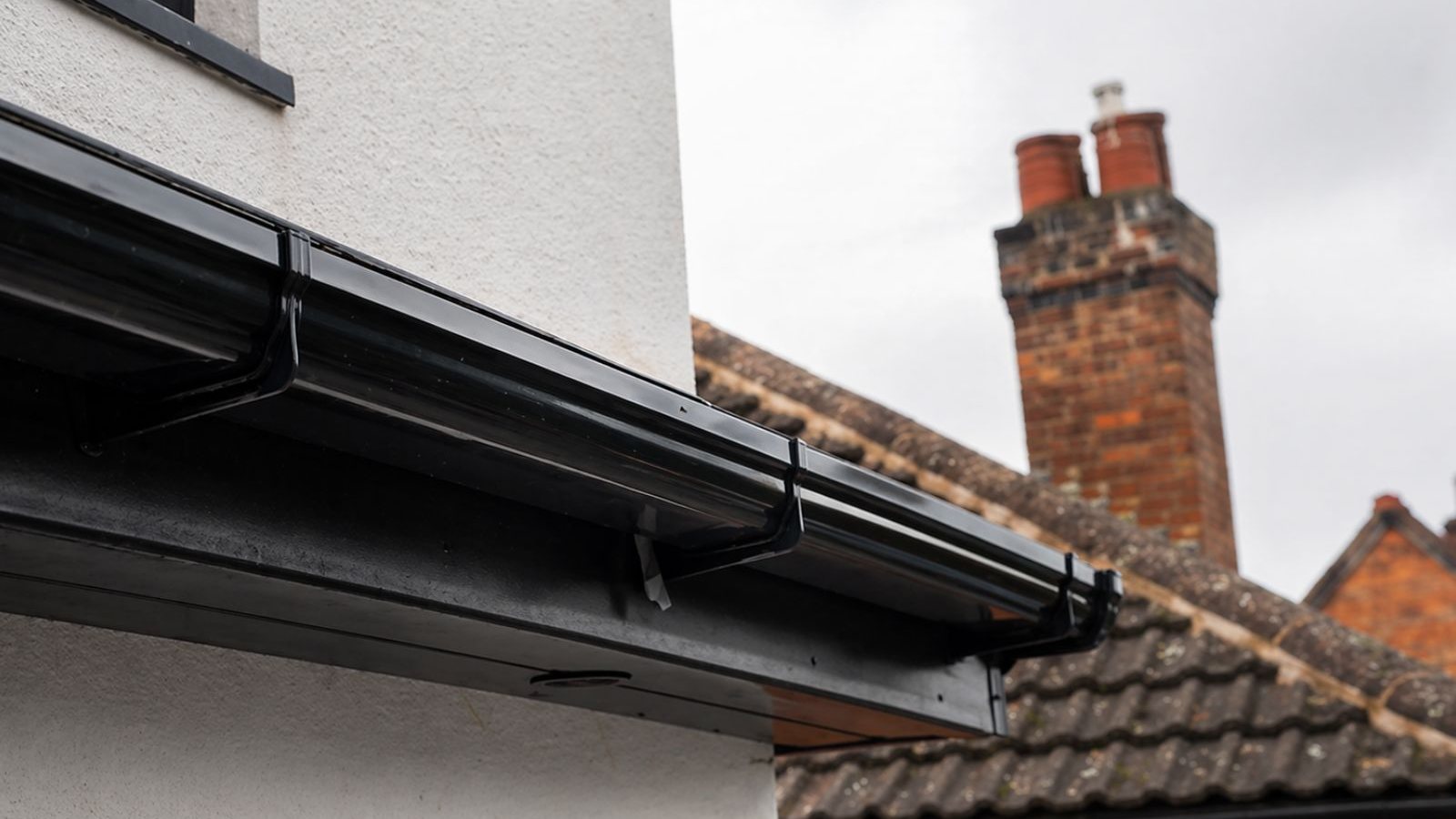 Black UPVC guttering fitted to a UK house